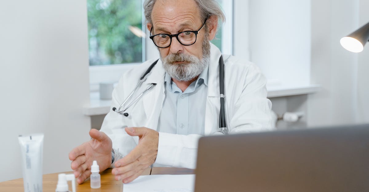 A compassionate doctor discusses treatment options with an elderly patient in a bright consultation room.