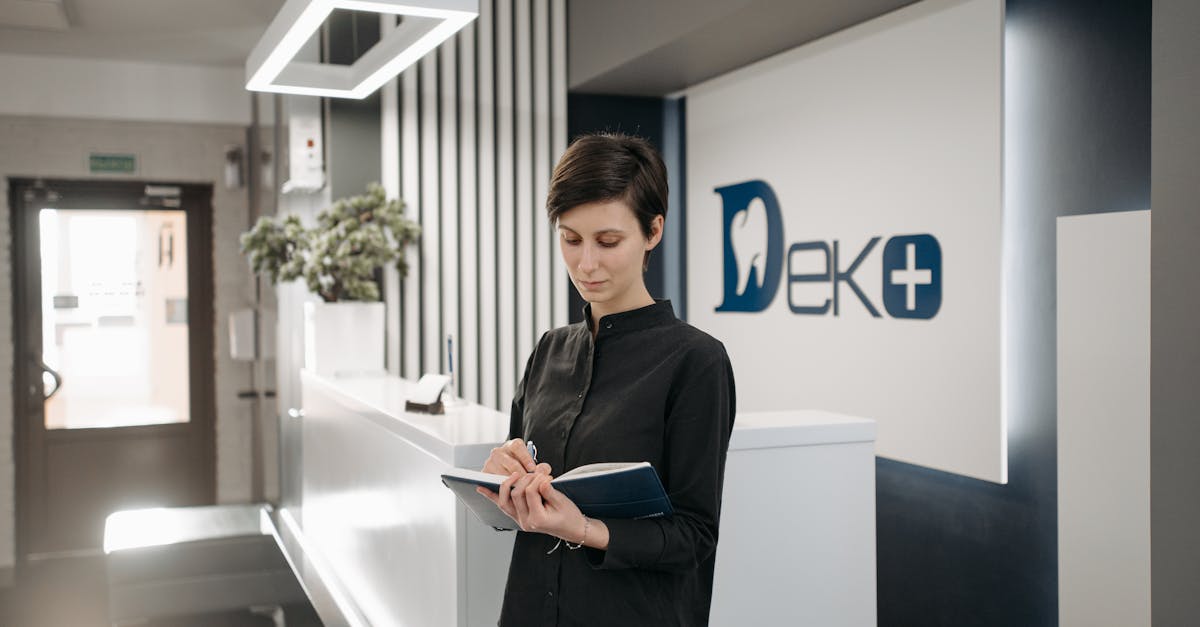 A calm and organized clinic reception area with a receptionist efficiently managing patient appointments on a modern computer system.