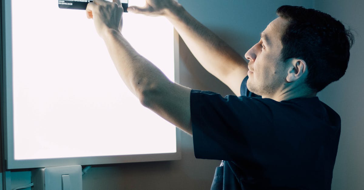 Doctor reviewing a patient's electronic health record on a desktop computer in a modern clinic office.