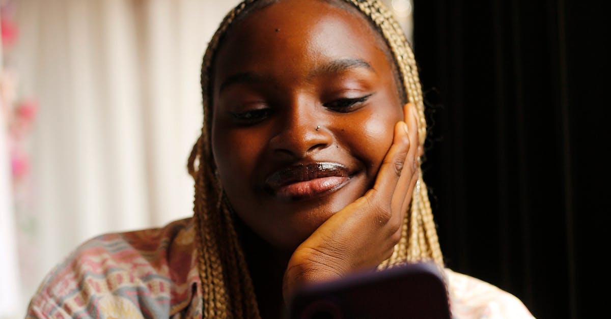 A patient smiling while using a smartphone to manage their healthcare appointments, symbolizing a positive digital experience.