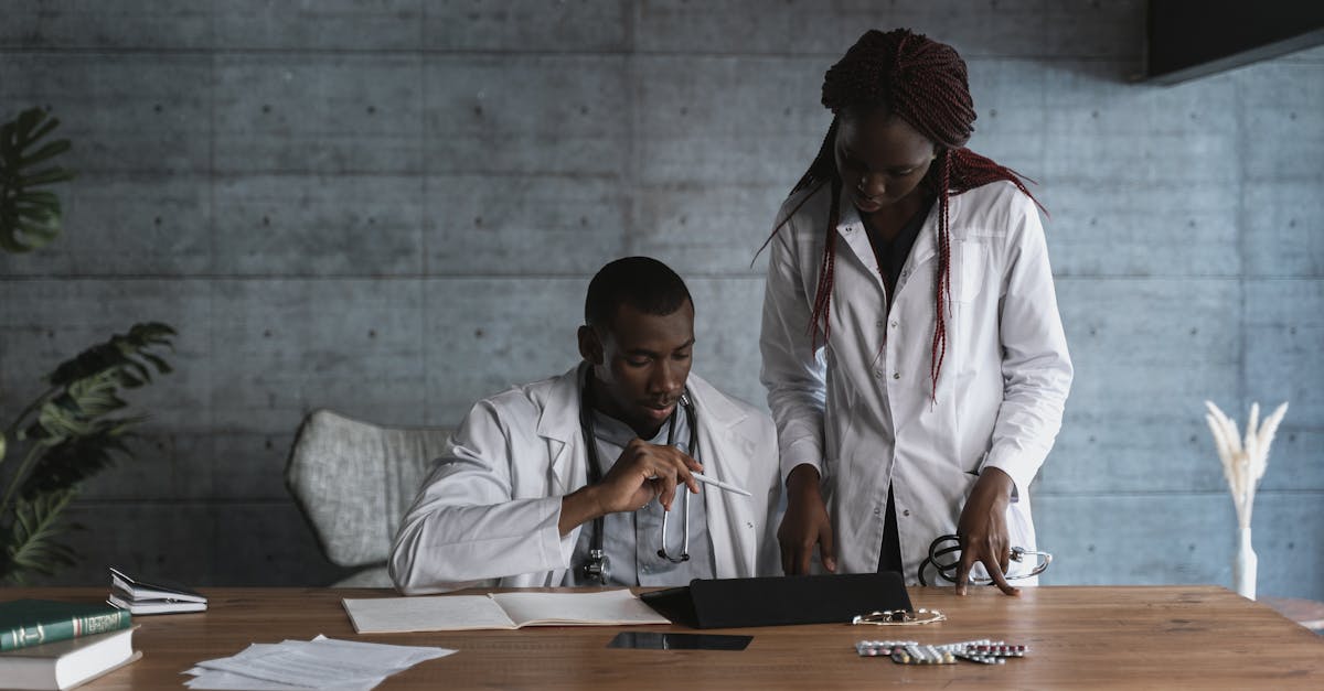 Healthcare professionals in a meeting discussing patient data security on a tablet.