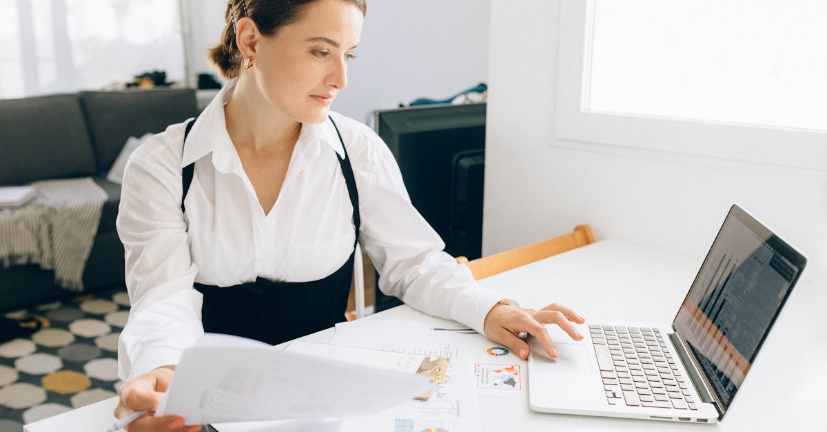 A healthcare administrator reviewing financial performance reports on a tablet using a comprehensive clinics system dashboard.