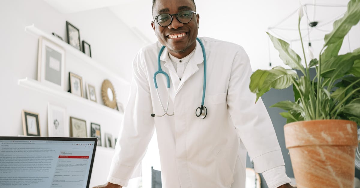 Modern clinic reception area with a receptionist using a management system on a desktop computer.