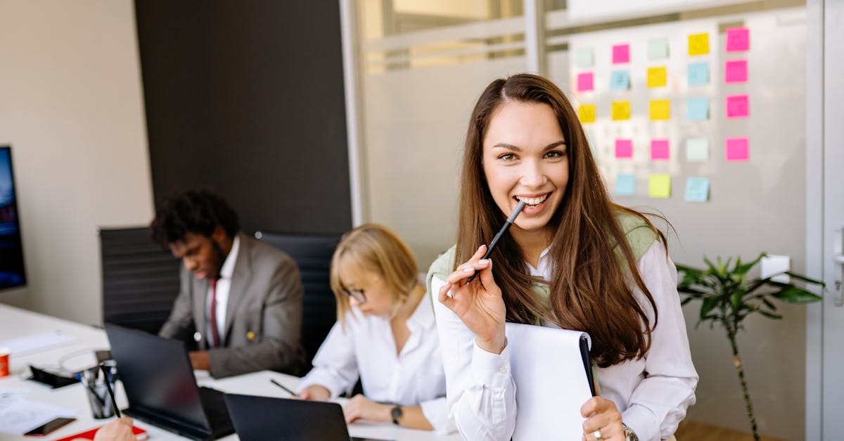 A team of healthcare professionals in a meeting room planning clinic launch strategy on a digital whiteboard.