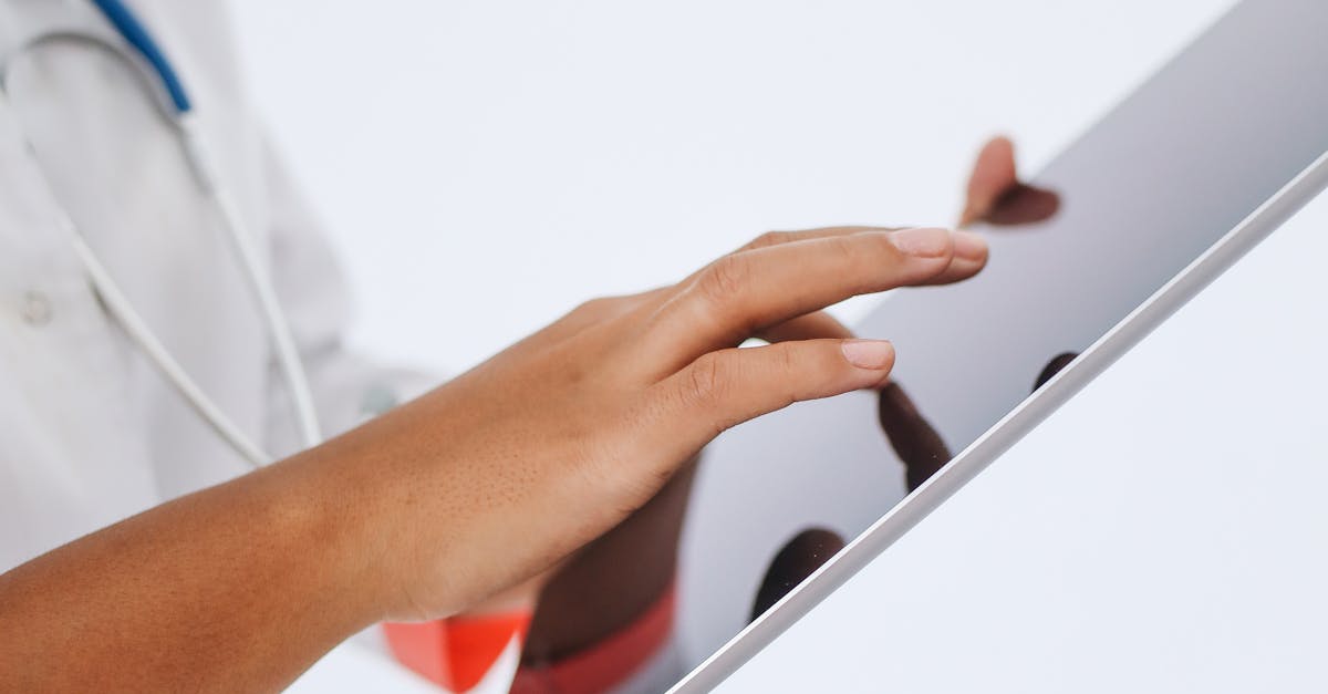 A doctor reviewing a patient's electronic health record on a tablet in a modern clinic setting.